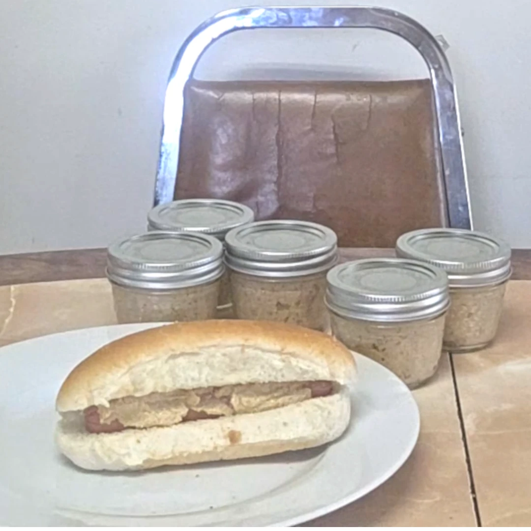 Hotdog with Dijon Mustard in front of jars of mustard