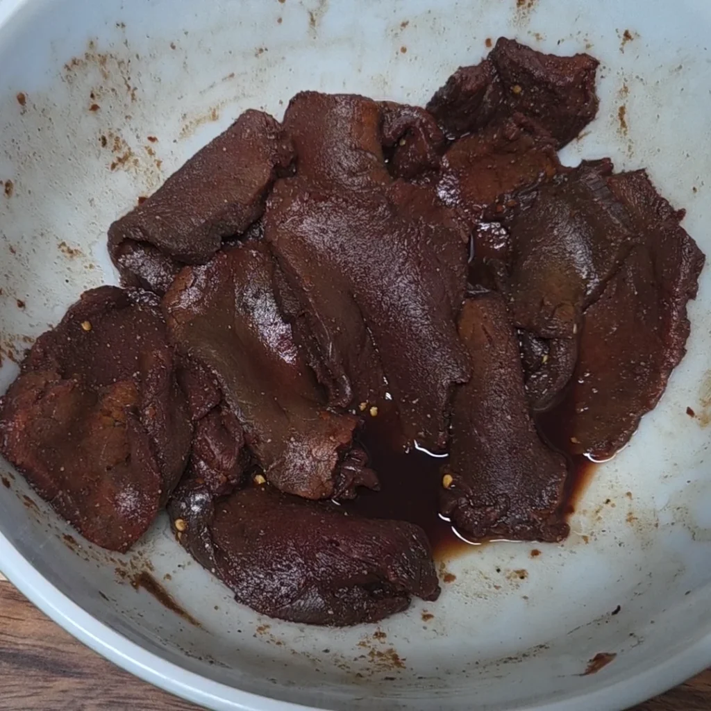 Meat and seasoning mixed in a bowl