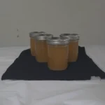 Jars of chicken stock on the table