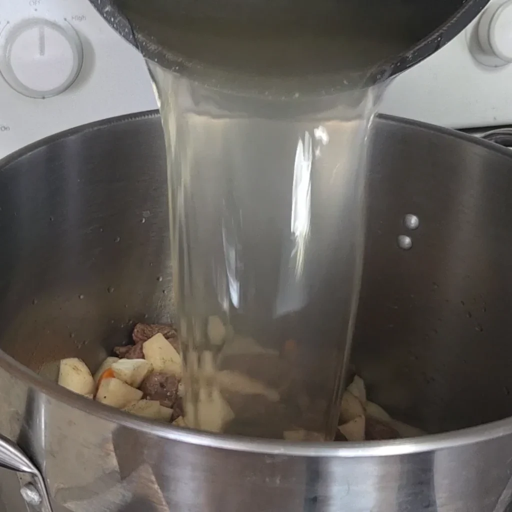 Pouring the stock into the broth