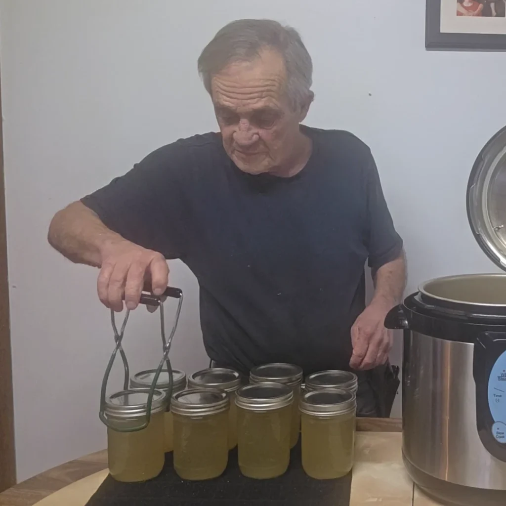 Pulling jars of stock out of the canner