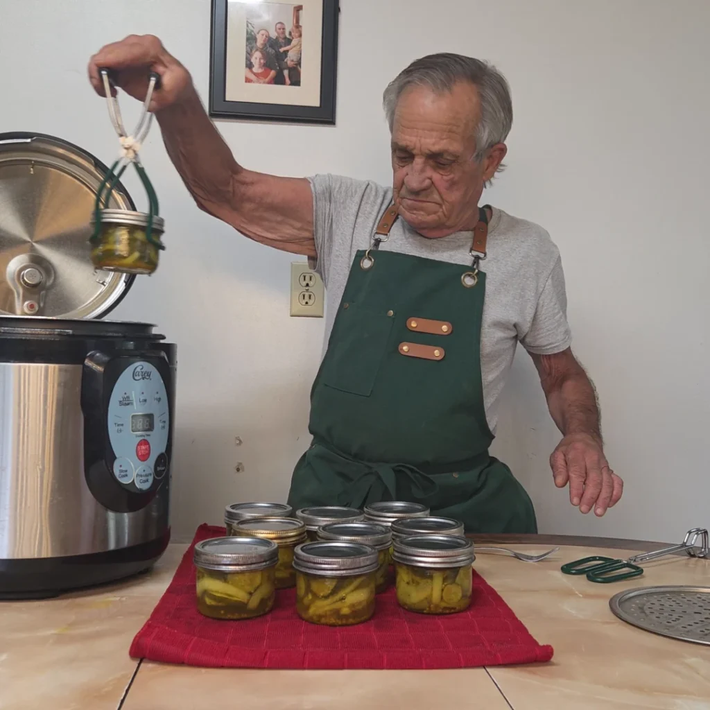 pulling  the jars of bread and butter pickles from the canner