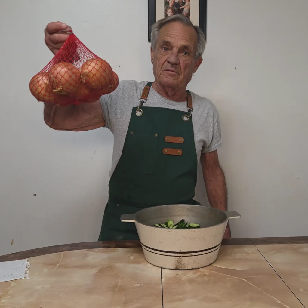 Holding a bag of onions over sliced cucumbers