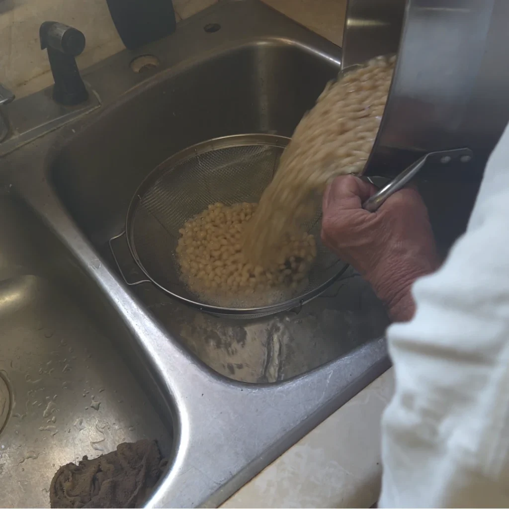 Straining the soaked beans