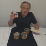Holding a jar of canned chicken and a chicken salad sanwich