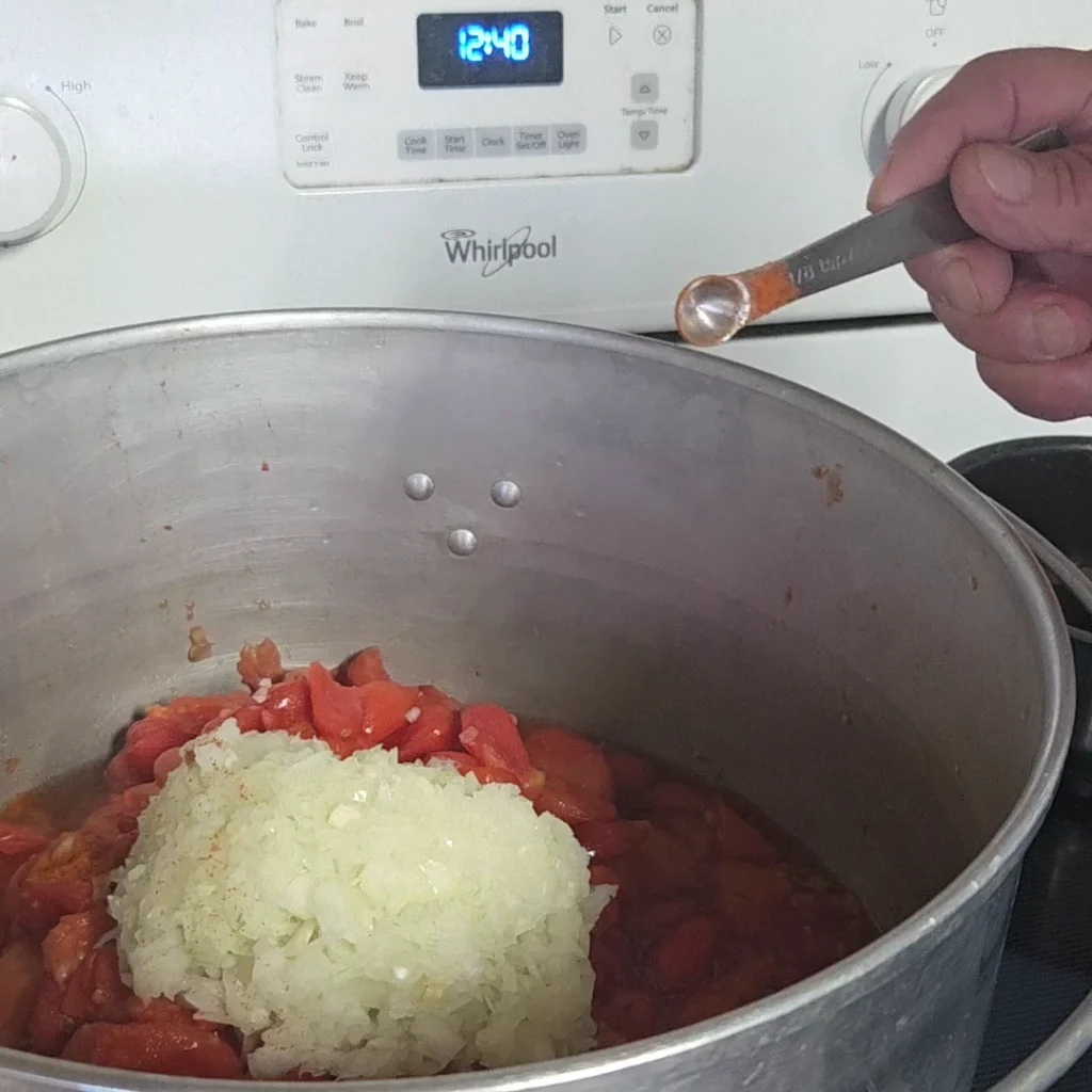 Add onions and cayenne pepper to tomatoes