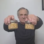 Gary holding two jars of canned turkey